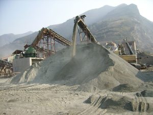 How does oil filter crusher adjust the ejection of material?